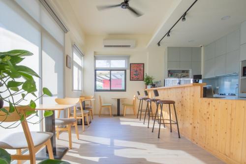 a room with tables and chairs and a counter at 這好宅 in Luodong