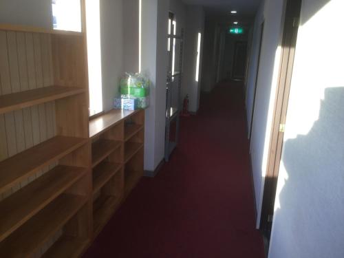 a hallway with wooden shelves and a long hallway at Homestay Dream / Vacation STAY 5063 in Uonuma