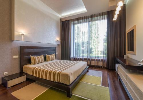 Postel nebo postele na pokoji v ubytování SunRay Resort&Spa