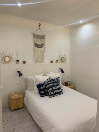 a bedroom with a large white bed with pillows at Chabanon in Marseille
