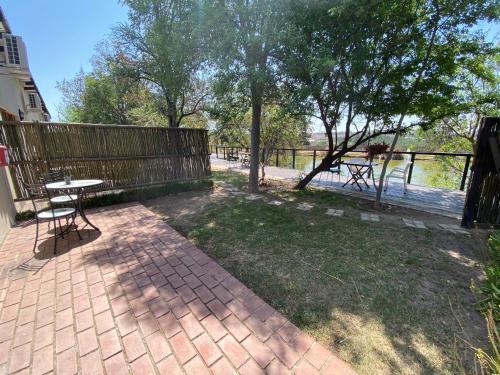 a patio with a picnic table and a fence at Lanseria Country Estate in Lanseria