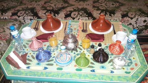 a table with a tray of pottery on it at Dar Pa Labzioui in Meknès