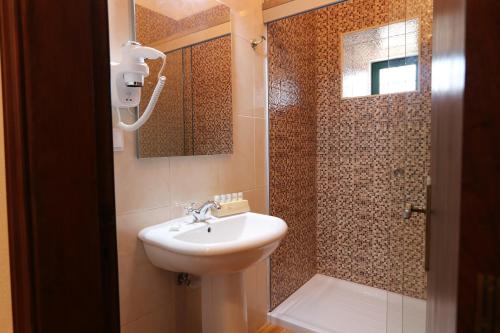 a bathroom with a sink and a shower at Casa do Feitor - Monte da Graça in Elvas