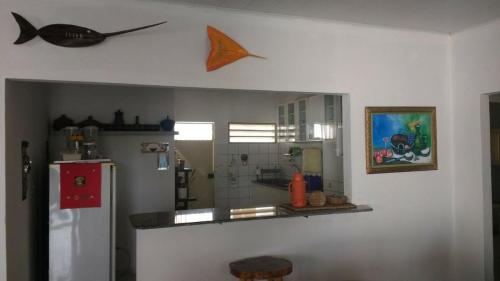 a kitchen with a refrigerator and a counter top at Casa Amarela in Paripueira