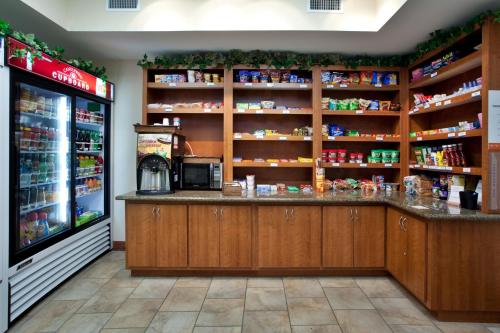 a grocery store with a counter and a refrigerator at Candlewood Suites New Iberia by IHG in New Iberia