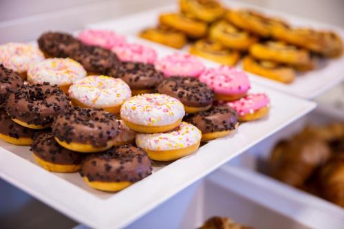 a display of different types of donuts in a bakery at Holiday Inn Express Amsterdam - Schiphol by IHG in Hoofddorp