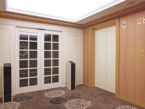 a room with a sliding glass door in a building at Hotel Nikko Kanazawa in Kanazawa