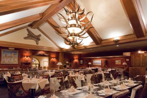 a dining room with tables and chairs and a chandelier at Crowne Plaza Albuquerque by IHG in Albuquerque