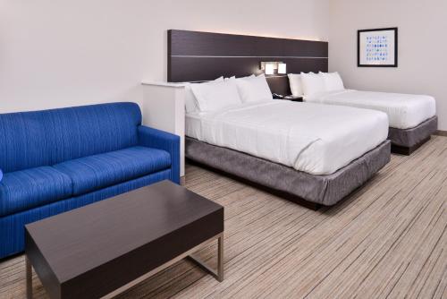 a hotel room with two beds and a couch at Holiday Inn Express - Bethlehem by IHG in Winder
