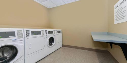 a laundry room with a washer and dryer at Holiday Inn Express - Alliance, an IHG Hotel in Alliance