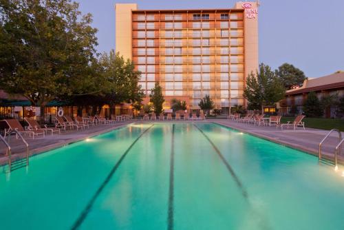 a swimming pool in front of a hotel at Crowne Plaza Albuquerque by IHG in Albuquerque