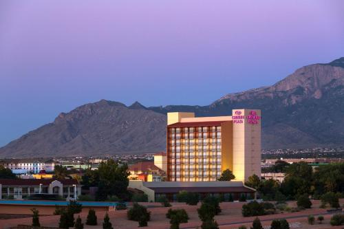 a hotel building with mountains in the background at Crowne Plaza Albuquerque by IHG in Albuquerque