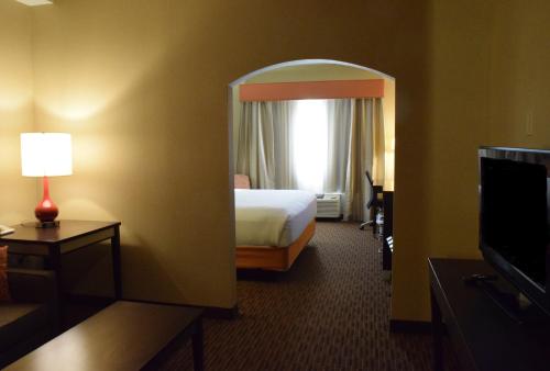 a hotel room with a bed and a window at Holiday Inn Express Hotel & Suites Watertown - Thousand Islands by IHG in Watertown