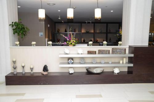 a lobby with vases on shelves in a building at Holiday Inn Express Baltimore West - Catonsville, an IHG Hotel in Catonsville