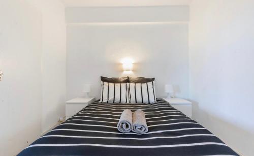 a bedroom with a bed with two slippers on it at Calafell playa lateral mar in Calafell