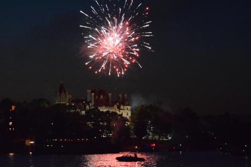 a firework display in the sky over a city at Holiday Inn Express Hotel & Suites Watertown - Thousand Islands by IHG in Watertown