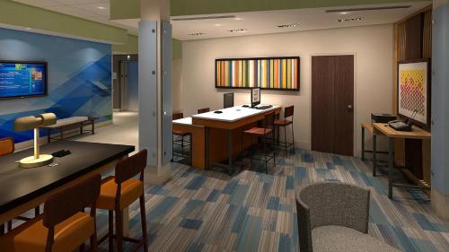 a lobby with a bar and some chairs and tables at Holiday Inn Express & Suites Blackwell by IHG in Blackwell