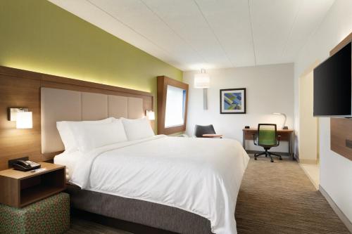 a hotel room with a large bed and a desk at Holiday Inn Express Hartford South - Rocky Hill, an IHG Hotel in Rocky Hill