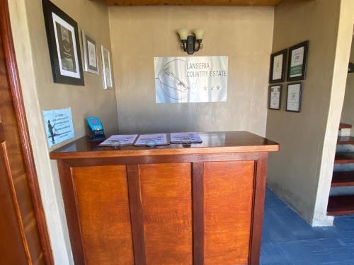 a wooden counter in a room with a phone on it at Lanseria Country Estate in Lanseria