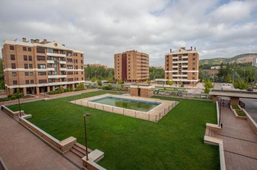 an aerial view of a city with a lawn and buildings at Cubell Home in Cuenca