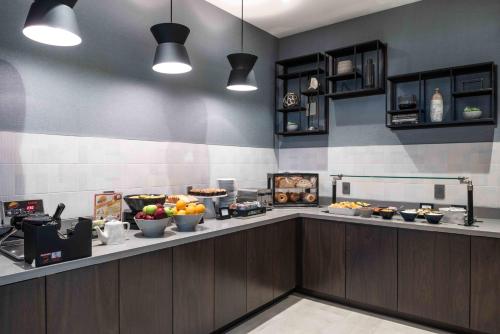 a kitchen with a counter with food on it at Holiday Inn Express - Boston South - Quincy by IHG in Quincy