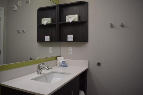 a bathroom with a sink and a mirror at Candlewood Suites - Nashville Metro Center, an IHG Hotel in Nashville