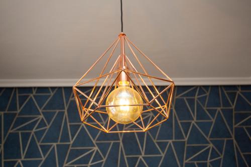 a chandelier hanging from a ceiling in a room at Cubell Home in Cuenca