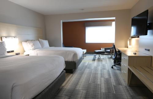 a hotel room with two beds and a flat screen tv at Holiday Inn Express - Biloxi - Beach Blvd by IHG in Biloxi