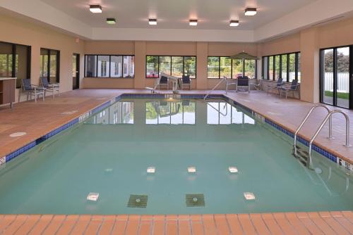 a swimming pool with blue water in a building at Holiday Inn Express Olean, an IHG Hotel in Olean
