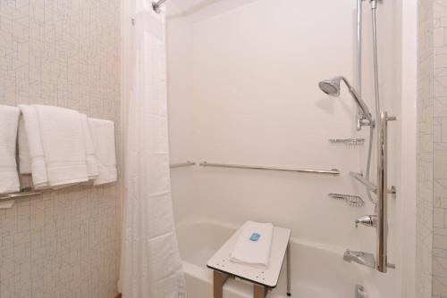 a white bathroom with a shower and a bath tub at Holiday Inn Express Olean, an IHG Hotel in Olean