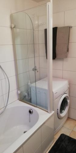 a bathroom with a sink and a washing machine at Ferienwohnung Sonnwald in Düsseldorf