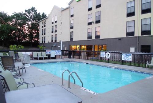 a large swimming pool with chairs and a building at Holiday Inn Express Hotel & Suites Blythewood by IHG in Blythewood