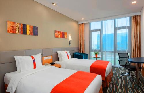 a hotel room with two beds and a window at Holiday Inn Express Beijing Yizhuang by IHG - Taxi 1 Hour to International Airport and 800 Meters to the Nearby Subway in Daxing