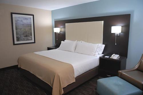 a hotel room with a large bed and a chair at Holiday Inn Express Boise Downtown by IHG in Boise