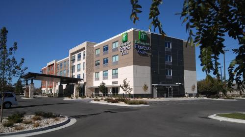 an office building with a parking lot in front of it at Holiday Inn Express & Suites Boise Airport by IHG in Boise