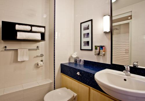 een badkamer met een wastafel, een toilet en een spiegel bij Holiday Inn Express Shrewsbury, an IHG Hotel in Shrewsbury