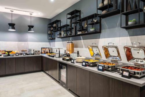 a buffet line with food on display in a restaurant at Staybridge Suites - Quincy by IHG in Quincy