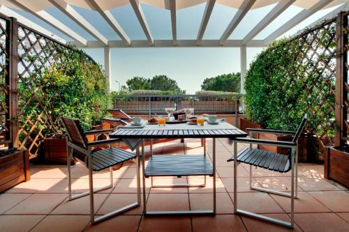 a table and chairs sitting on a patio at Cocca Hotel Royal Thai Spa in Sarnico