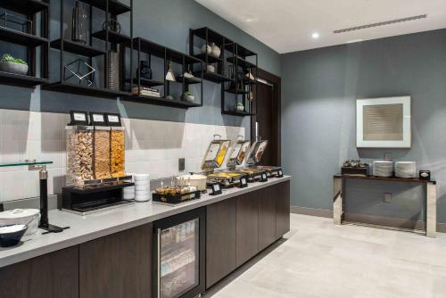a kitchen with a counter with food on it at Staybridge Suites - Quincy by IHG in Quincy