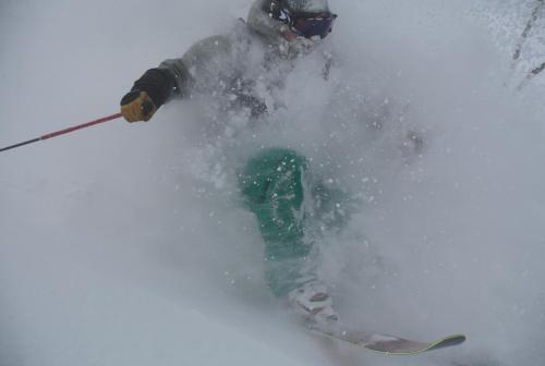 a person is skiing down a snow covered slope at Il Bosco in Hakuba