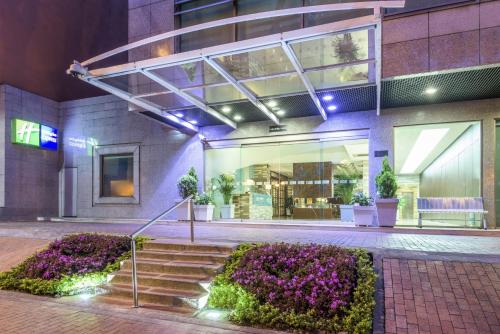 a building with stairs and flowers in front of it at Holiday Inn Express Bogotá - Parque La 93 by IHG in Bogotá