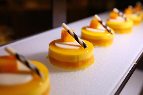 a group of caramel desserts on a table at Junluxe Hotel Guangzhou Zengcheng-Free Shuttle Bus For Canton Fair in Zengcheng