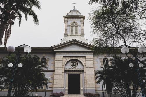 a church with a clock tower on top of it at Hotel del Parque in Guayaquil