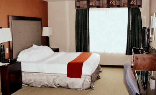 a hotel room with a bed and a window at Holiday Inn Express & Suites Bozeman West by IHG in Bozeman