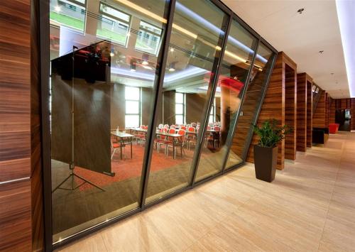 a reflection of a dining room in the windows of a building at Holiday Inn Trnava by IHG in Trnava