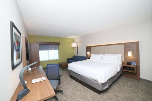 a hotel room with a bed and a desk at Holiday Inn Express Naperville by IHG in Naperville