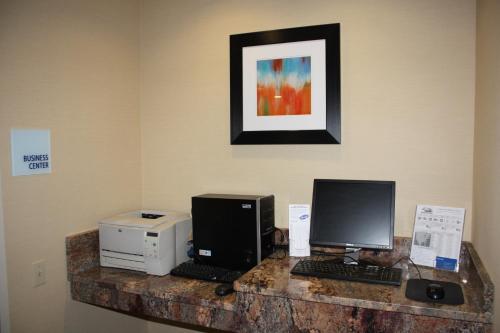 a desk with two computers and a printer at Holiday Inn Express - Ludlow - Chicopee Area by IHG in Ludlow