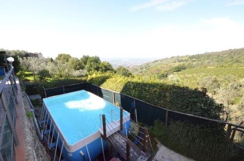 a swimming pool on the side of a house at Casa Mela in Vinci