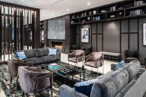 a living room with couches and chairs and a fireplace at Holiday Inn Express - Boston South - Quincy by IHG in Quincy