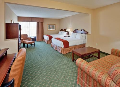 a hotel room with two beds and a television at Holiday Inn Express Hotel & Suites Cape Girardeau I-55 by IHG in Cape Girardeau
